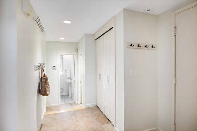 corridor with light tile patterned floors