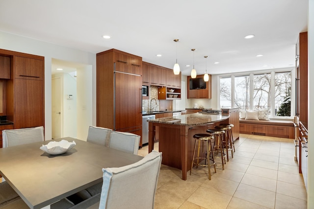 kitchen featuring sink, stainless steel dishwasher, and light tile patterned floors