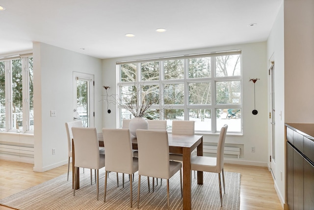 dining area with a healthy amount of sunlight and light hardwood / wood-style flooring