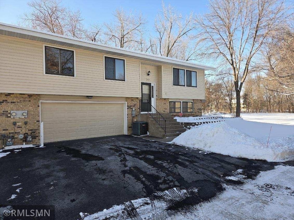 bi-level home with cooling unit and a garage