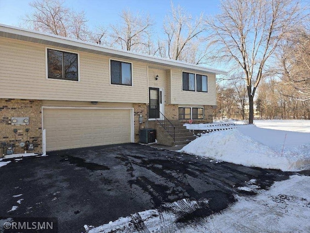 bi-level home with cooling unit and a garage