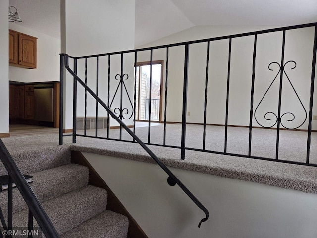 staircase with vaulted ceiling