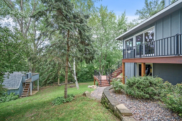 view of yard featuring stairway and a wooden deck