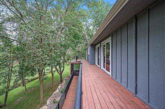 wooden terrace featuring a yard