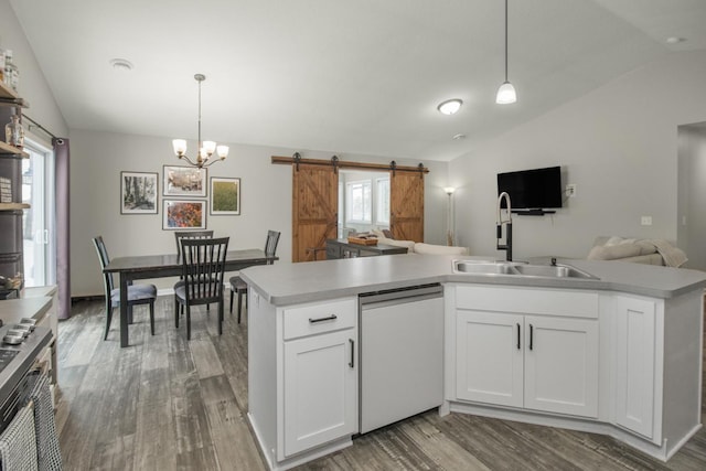 kitchen with a barn door, decorative light fixtures, dishwashing machine, and white cabinets