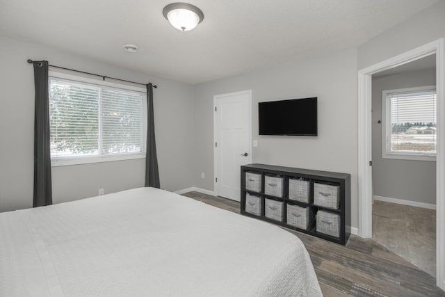 bedroom with dark wood-type flooring