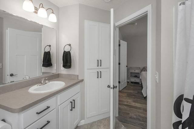 bathroom with vanity and wood-type flooring