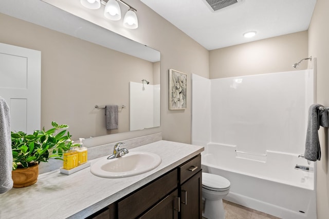 full bathroom featuring vanity, toilet, tile patterned floors, and  shower combination