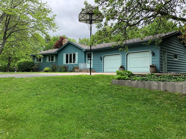 single story home featuring a garage and a front lawn