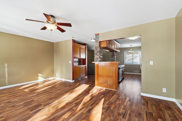 kitchen featuring visible vents, brown cabinets, a ceiling fan, dark wood finished floors, and baseboards