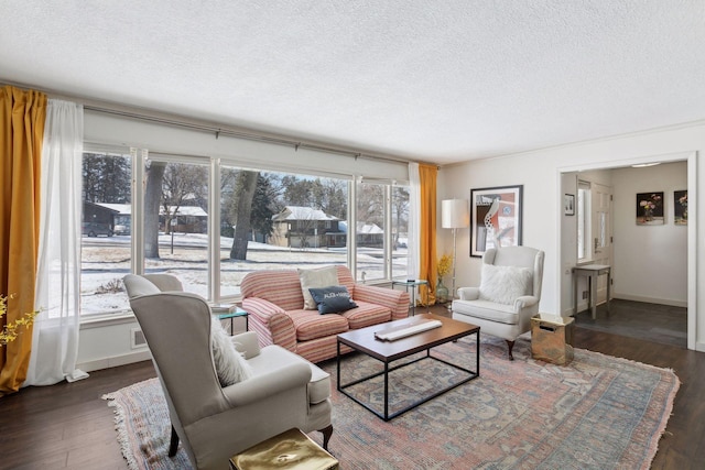 living room featuring a healthy amount of sunlight, a textured ceiling, and dark hardwood / wood-style flooring