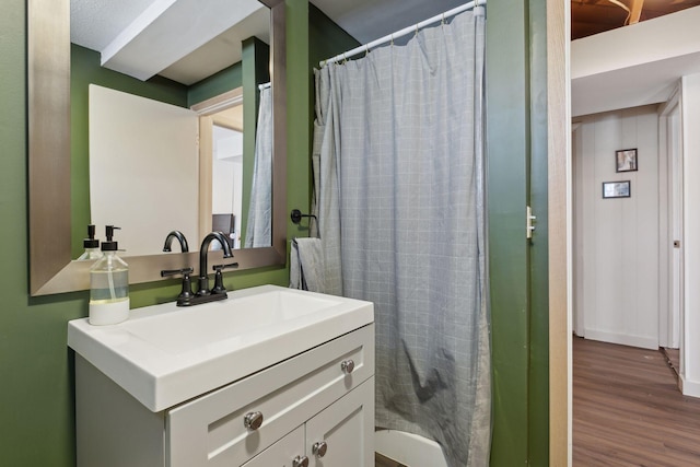 bathroom featuring vanity, hardwood / wood-style flooring, and curtained shower