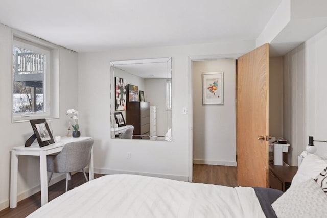 bedroom with dark hardwood / wood-style flooring