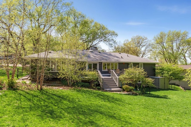 back of property featuring a yard and a deck