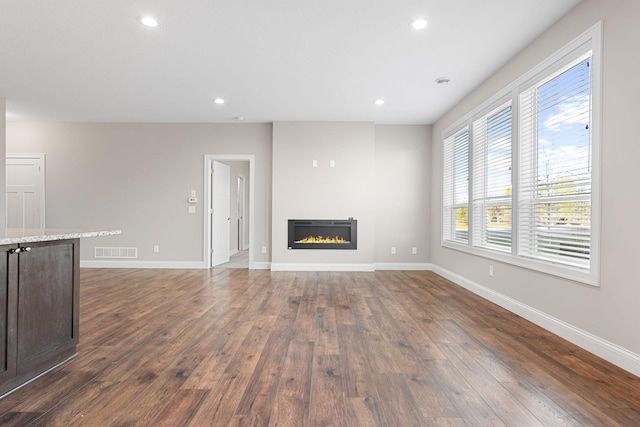 unfurnished living room featuring dark hardwood / wood-style floors