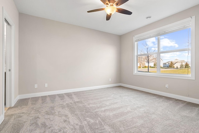 carpeted empty room featuring ceiling fan