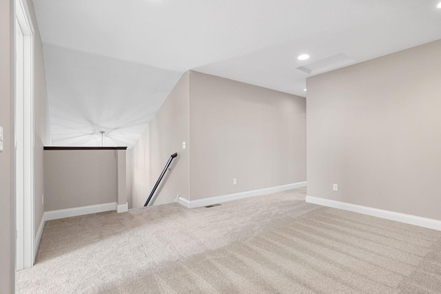 additional living space featuring light carpet