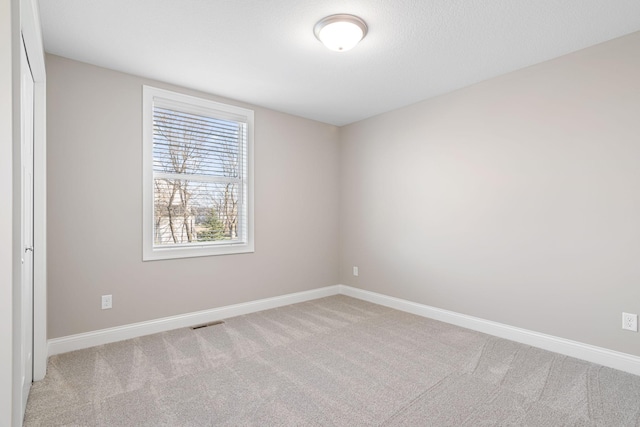 unfurnished room with light carpet