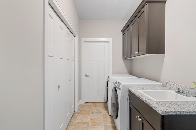 laundry room featuring cabinets, washing machine and clothes dryer, and sink