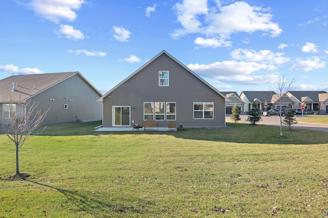 rear view of house featuring a patio and a yard