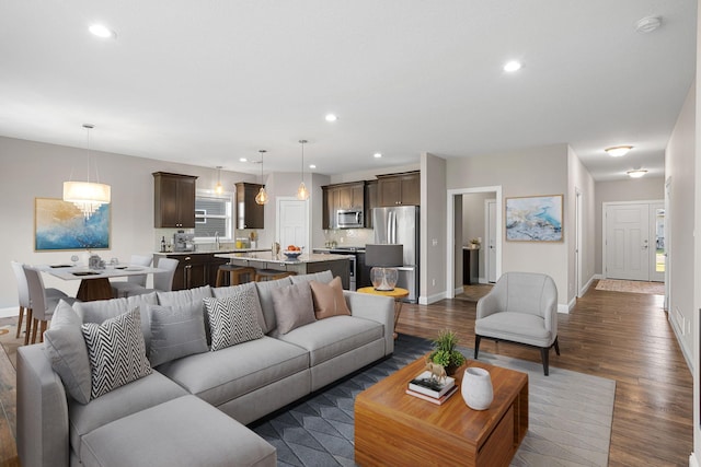 living room featuring dark hardwood / wood-style floors and sink