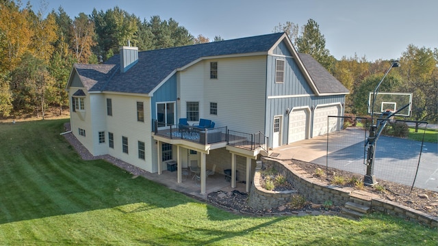 rear view of property featuring a wooden deck and a lawn