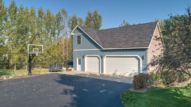 garage with a trampoline and basketball hoop