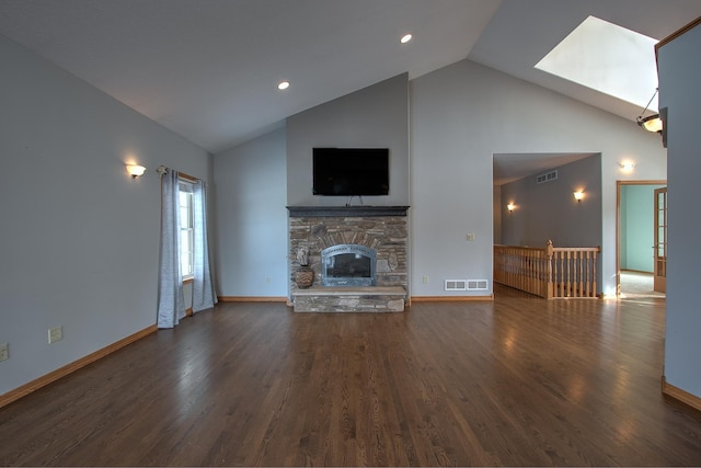 unfurnished living room with a skylight, a fireplace, dark hardwood / wood-style flooring, and high vaulted ceiling