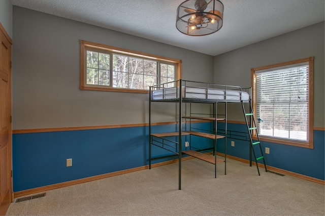 unfurnished bedroom featuring carpet and a textured ceiling