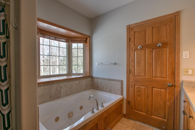 bathroom with vanity, tile patterned floors, and a tub to relax in