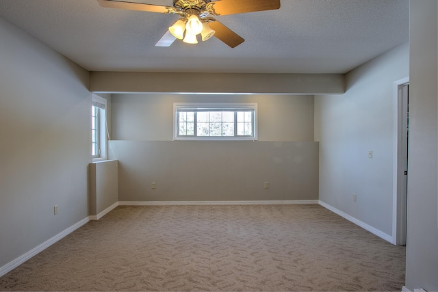 carpeted spare room with ceiling fan and a textured ceiling