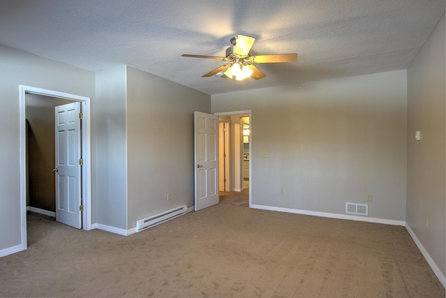 spare room featuring a baseboard radiator, carpet flooring, a textured ceiling, and ceiling fan