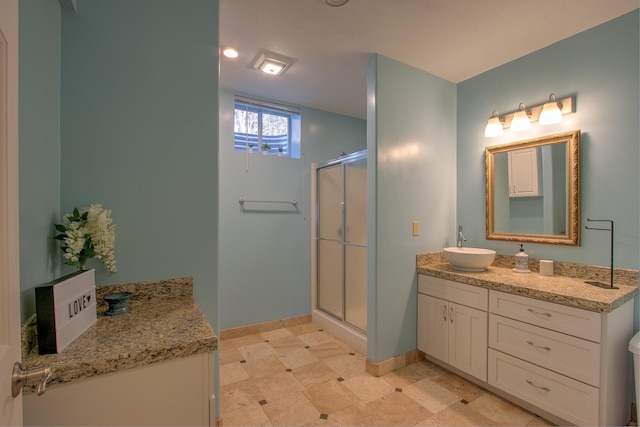 bathroom with vanity and a shower with door