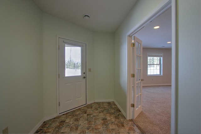 doorway to outside featuring carpet floors