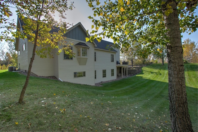 view of home's exterior with a yard and cooling unit