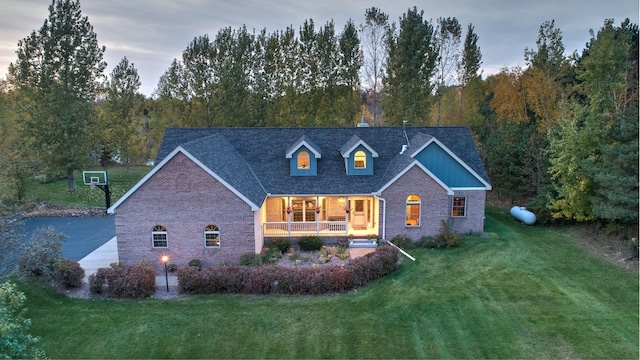 view of front of house with a lawn and a porch