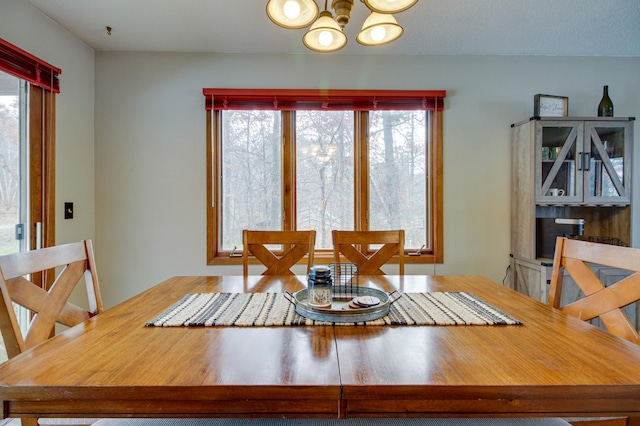 dining space with an inviting chandelier