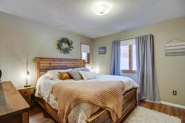 bedroom featuring wood-type flooring and a textured ceiling