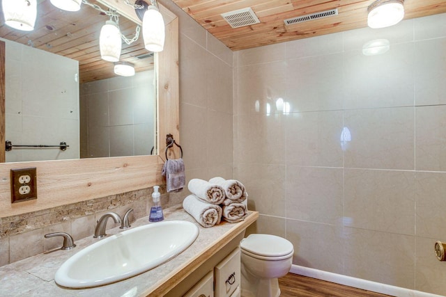 bathroom with toilet, tile walls, wooden ceiling, vanity, and hardwood / wood-style flooring