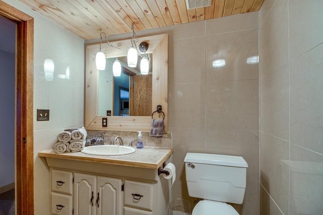 bathroom featuring tile walls, vanity, wood ceiling, and toilet