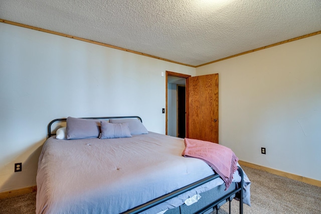 bedroom with ornamental molding, carpet floors, and a textured ceiling