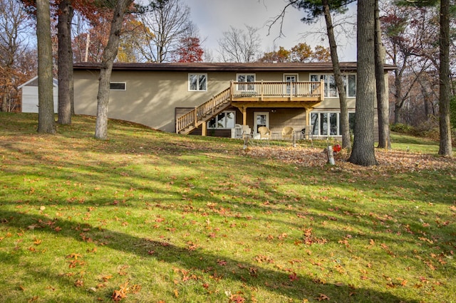 rear view of property with a lawn and a deck