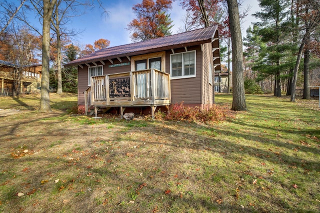 exterior space with a wooden deck and a yard