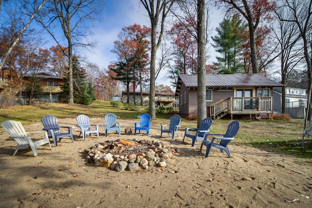 view of yard featuring a fire pit and a deck