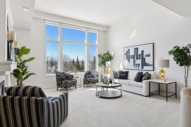 living room featuring a glass covered fireplace and carpet floors