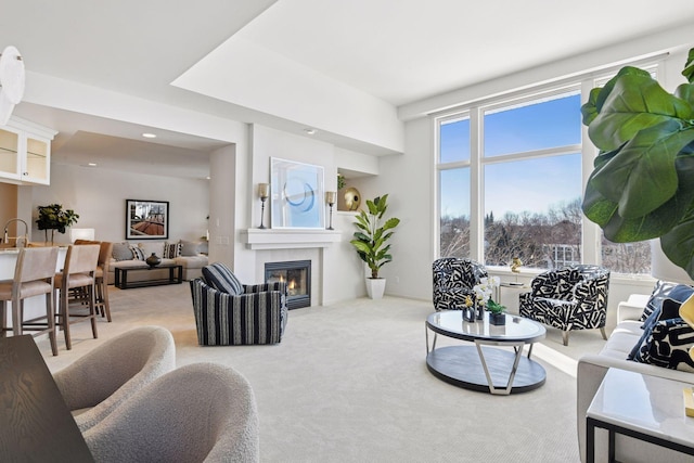 living room with light carpet, recessed lighting, and a tile fireplace