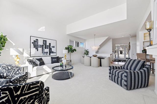 living room featuring carpet flooring and a chandelier