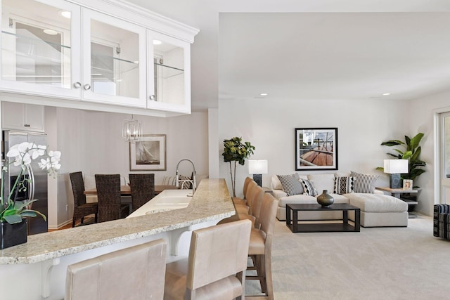 dining area featuring recessed lighting and light colored carpet