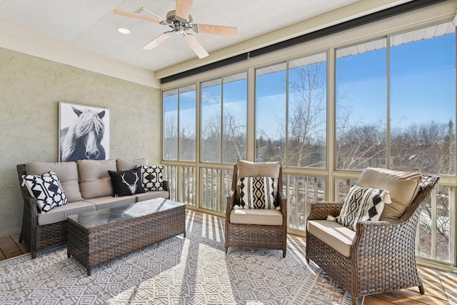 sunroom / solarium featuring plenty of natural light and a ceiling fan