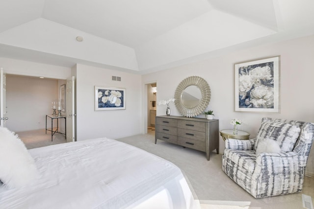 carpeted bedroom featuring visible vents, a raised ceiling, and vaulted ceiling